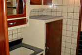 Cool un-restored kitchen tile, cabinets and sink in 1937 Royal Wilheim Trailer